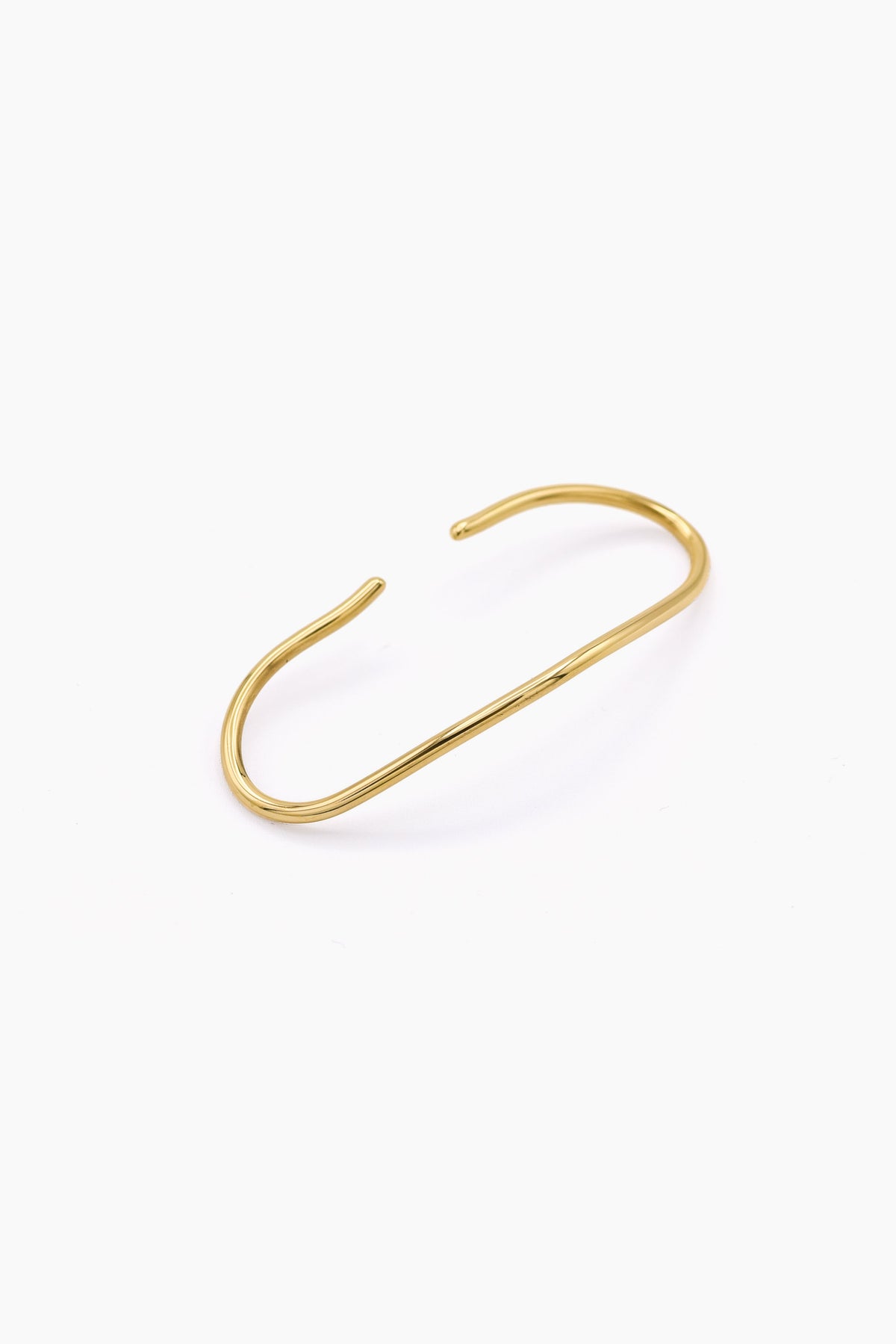 A minimalist gold wire cuff handcuff with an open, curved design, displayed on a clean white background. Handmade in Brass and silver
