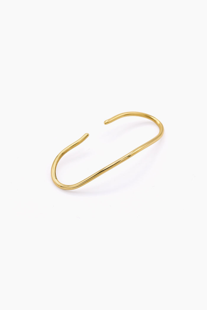 A minimalist gold wire cuff handcuff with an open, curved design, displayed on a clean white background. Handmade in Brass and silver